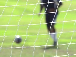 A man playing soccer on a grassy field. - Slow Motion - filmed at 240 fps Stock Footage