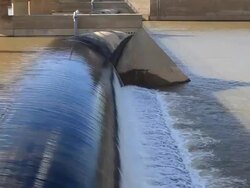 Flowing water at small dam Stock Footage