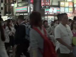 Pedestrians crossing street at crosswalk in Shinjuku, Tokyo, Japan. Stock Footage