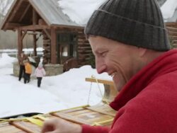MS Father tying toboggan on top of car and family coming out of house / Sun Valley, Idaho, United States Stock Footage