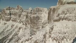 Snow dusts rugged mountain cliffs and plateaus. Stock Footage
