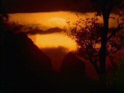 CU sun at dusk partially covered by clouds, Botswana, Africa Stock Footage