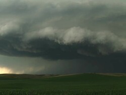 WS View of scary and dark clouds churning as supercell thunderstorm nears over corn and hills / Nebraska, United States Stock Footage