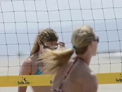 CU of female beach volleyball players spiking and blocking at the net. Stock Footage