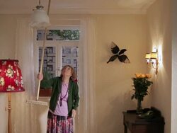 MS Senior woman irritated and hitting the ceiling with broom  / Berlin, Germany Stock Footage