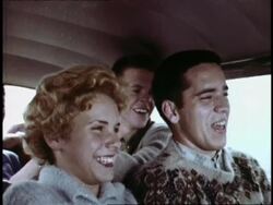 Teenagers pile into '57 Chevy to avoid the rain Stock Footage
