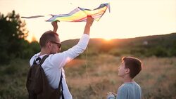 Father and son flying kites Stock Footage