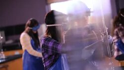 Students share tablets to conduct chemistry lab experiment Stock Footage