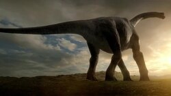 A dinosaur lays an egg while standing in a field at sunset in a computer generated animation. Stock Footage