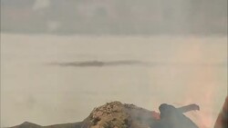 A man tends a fire during a cremation ritual in Diwali, India. Stock Footage