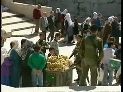 MS High angle, Banana stall, People crowded around, armed soldiers looking on, Jerusalem Stock Footage