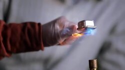 Teacher supervises a student using Bunsen burner Stock Footage
