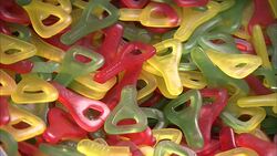 A scoop removes fruit-filled wax candies. Stock Footage