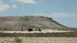 Texas wind turbines oil pump jack drilling rig Chihuahuan desert Stock Footage