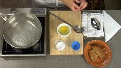 Overhead how to poach and egg in a pan of boiling water on the stove. Stock Footage