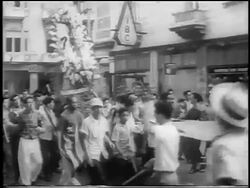 B/W 1959 crowd of men carrying banner + float in celebration of revolution / Havana / news. Stock Footage