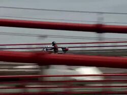 WS AERIAL TS ZI ZO View of motorbike crossing "Ponte 25 de Abril" / Lisbon, Portugal   Stock Footage
