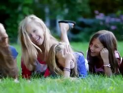 MS PAN Shot of preteen girls gossiping on grass / Manchester, Vermont, United States Stock Footage