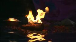 Flames from floating candles burn at night. Stock Footage