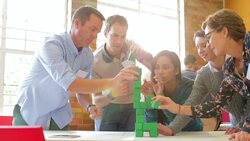 Business people stacking green blocks Stock Footage