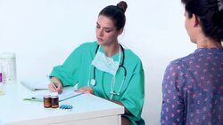 Doctor writing medical prescription to patient Stock Footage