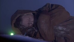 A freezing accident victim stirs as the flashing lights of a rescue vehicle approaches. Stock Footage