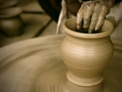 Indian potterâ€™s skilled hand shaping pot on manual pottery wheel Stock Footage