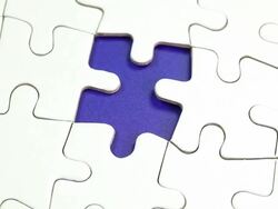 The solution - Hand places piece into puzzle Stock Footage