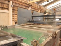 Steel Mill - Coils lifted from bath Stock Footage