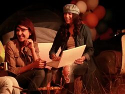 Three young women using laptop in the forest, Delhi, India Stock Footage