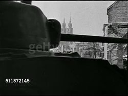 1944: DESTRUCTION IN EUROPE: CU Allied tank moving FG w/ bombed city of Cologne BG, cathedral spires still standing. VS Bombed smoking buildings, windows blown out of older structure possibly house of worship. WWII, World War II. Instructional Video