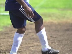 A man playing soccer on a grassy field. - Slow Motion - filmed at 240 fps Stock Footage