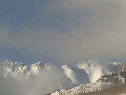 MS T/L View of Clouds and Snow Rolling over Majestic Mountain Peaks in evening Light / Telluride, Colorado, United States Stock Footage