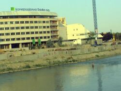 WS Building under construction, man fishing in foreground / Skopje, Macedonia Stock Footage