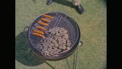 MS HA Man grilling sausages on barbecue grill / United States Stock Footage
