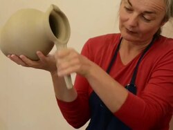 MS Shot of female potter shapes and makes handle to pitcher / Landshut, Bavaria, Germany Stock Footage
