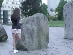 MS Shot of Back angle on young woman as stretches and prepares for her morning jog before dawn on city water front / Portland, Oregon, United States  Stock Footage