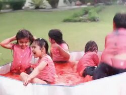 Group of kids playing holi festival in a lawn  Stock Footage