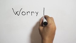 Hand writing a 'Worry less smile more' message on a white board using a black marker Stock Footage
