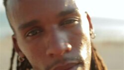 Brazilian capoeira fighter with dreadlocks stares at camera Stock Footage