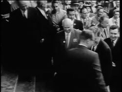 B/W 1960s John Kennedy + Nikita Khrushchev walking up stairs surrounded by crowd / Germany Stock Footage