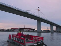 MS Punt passing under vast span of Westgate Bridge crossing Yarra River / Melbourne, Victoria, Australia Stock Footage