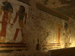 Medium, pan-right push-in  - Murals depict ancient Egyptian life in a low-ceiling room Stock Footage