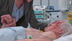 Daughter visiting father in ICU after surgery with her husband Stock Footage