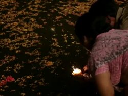 MS Woman putting offerings into Ganges river / Varanasi, India Stock Footage