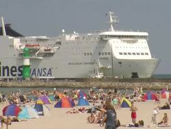 WS Crowded beach and ferry ship moving on river / Warnemuende near Rostock, Mecklenburg-Western Pomerania, Germany Stock Footage