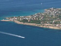 MS AERIAL Shot of coastline and islands near piraeus with sailboat / Piraeus, Peloponnese, Greece Stock Footage