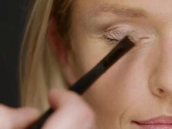 ECU Woman having light eye shadow put on / Copenhagen, Denmark Stock Footage
