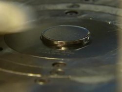 Machine striking a Prince George baptism coin News Clip