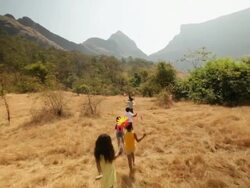 Group of kids playing with paper windmill in the forest Stock Footage